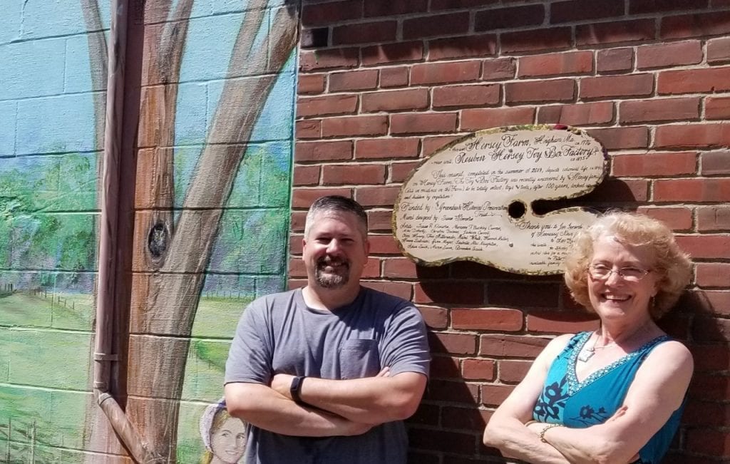 Hennessy's owner Joe Lerardi with Susan Kilmartin -- he's pleased with the mural! The sign is engraved with names of contributing artists.
