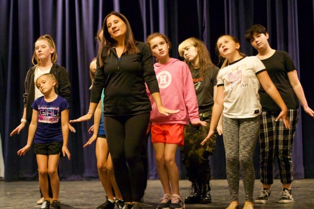 “Seussical The Musical” choreographer Liz Tronni, of Hingham, rehearses ensemble members for the song “Here on Who.” (Photo by Kerry Tondorf)

