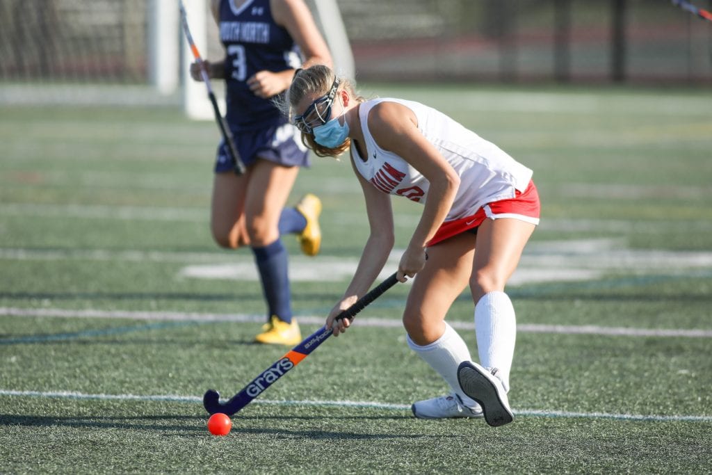 Senior Captain Audrey Cole gets the ball out of Hingham's end in the first half. 