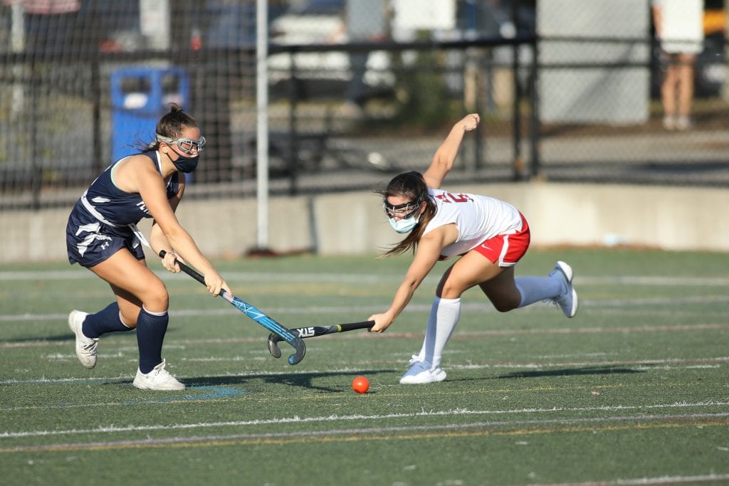 Sophomore Ellie Savitscus stretches to knock the ball away from her opponent.  