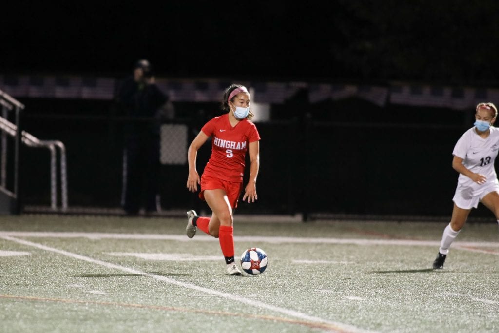 Junior Riley Cotter brings the ball over half field into Whitman-Hanson's end. 