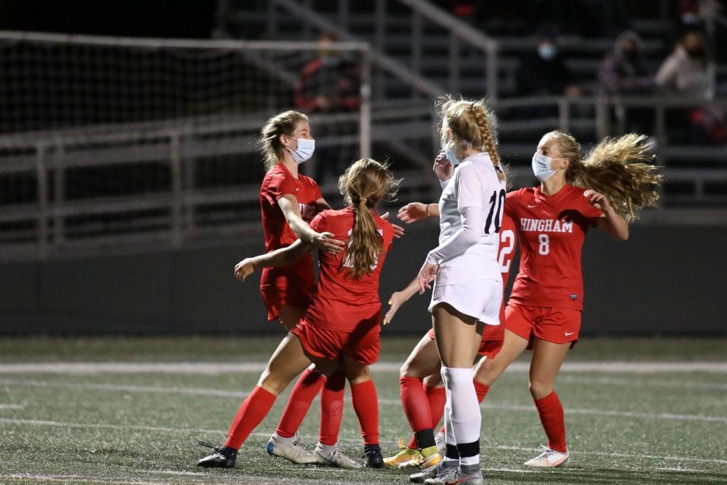 Sophomore Emily Gibbons celebrates with her teammates after her goal gives Hingham the 2-1 lead. 