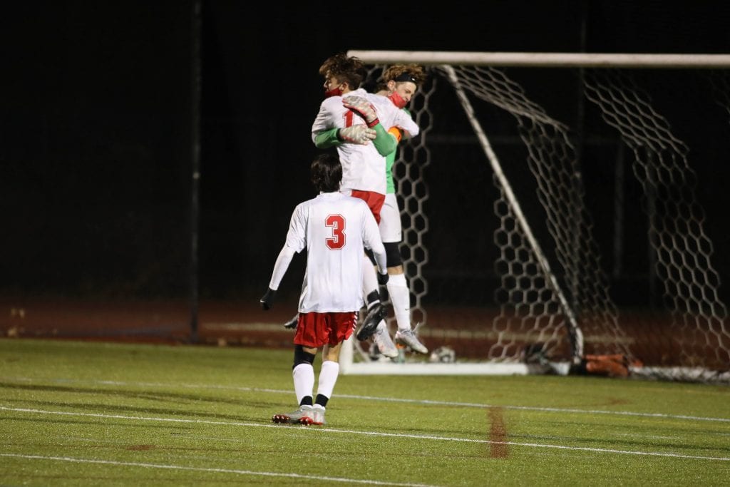 Senior captain and goalie Trent Hesselman celebrates their win and trip to the Patriot Cup Finals. 