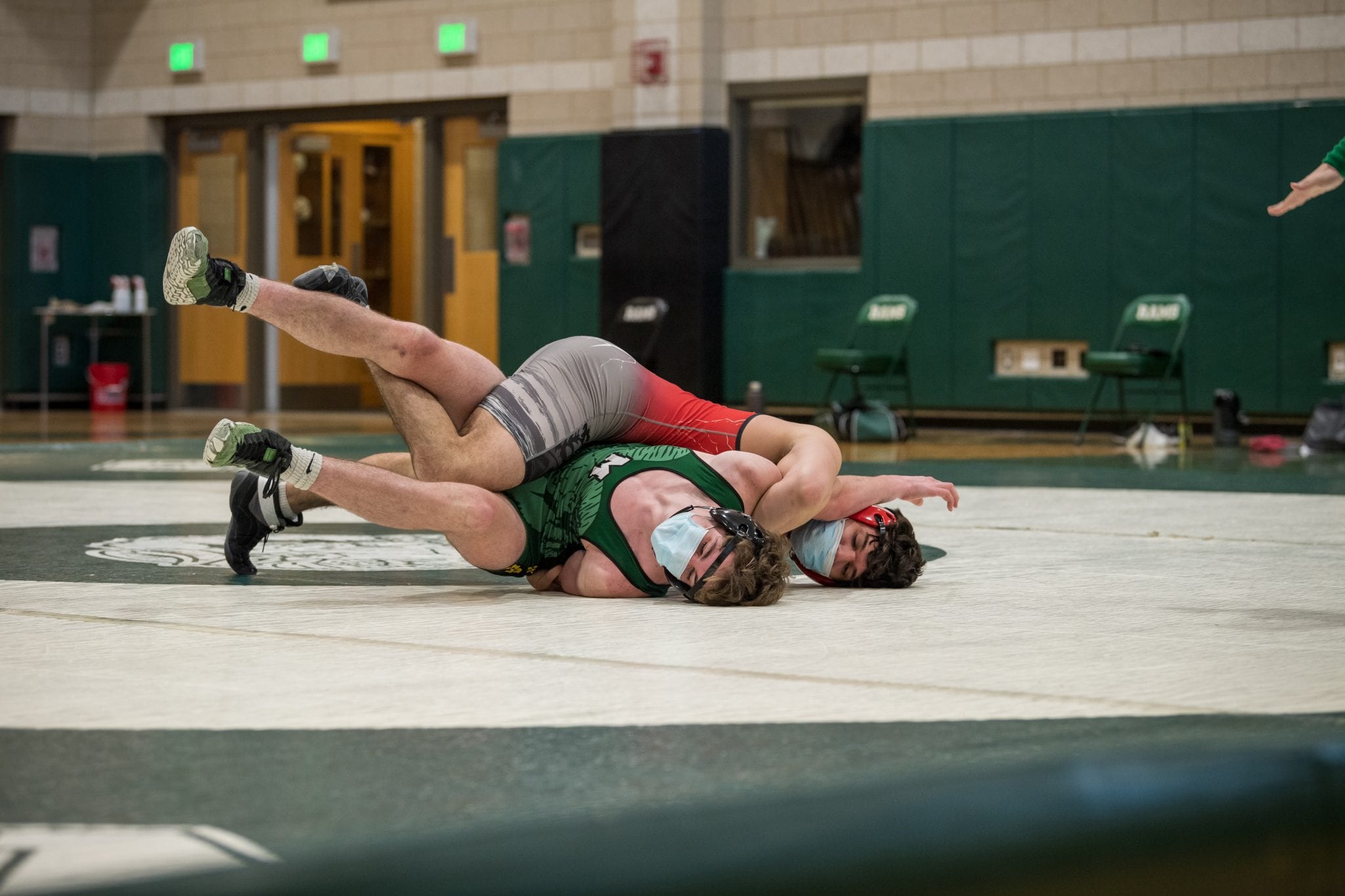 Senior captain Joe Wiley (170) attempting to pin his opponent.  (Photo by Fotique.)