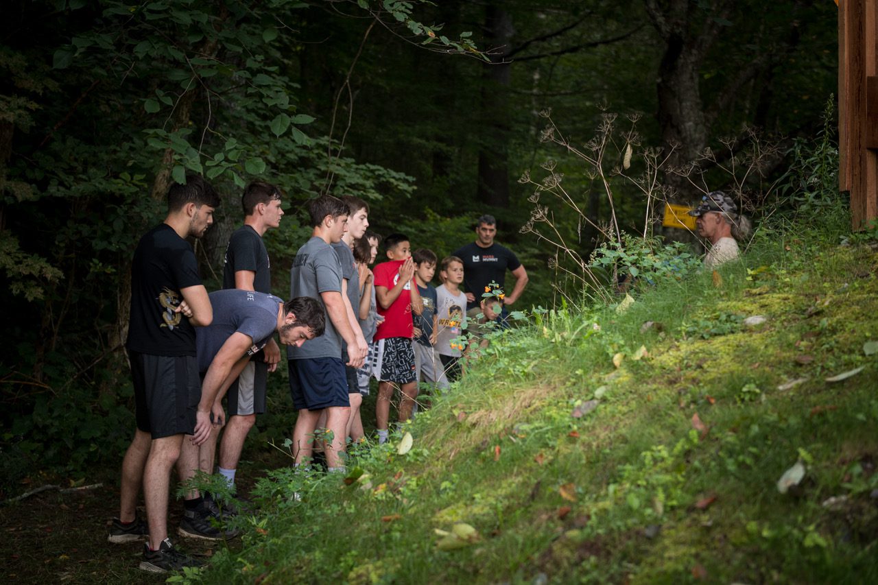 Wrestlers line up as they finish a mountain workout with their coaches at Camp Spartan in Pittsfield, VT.