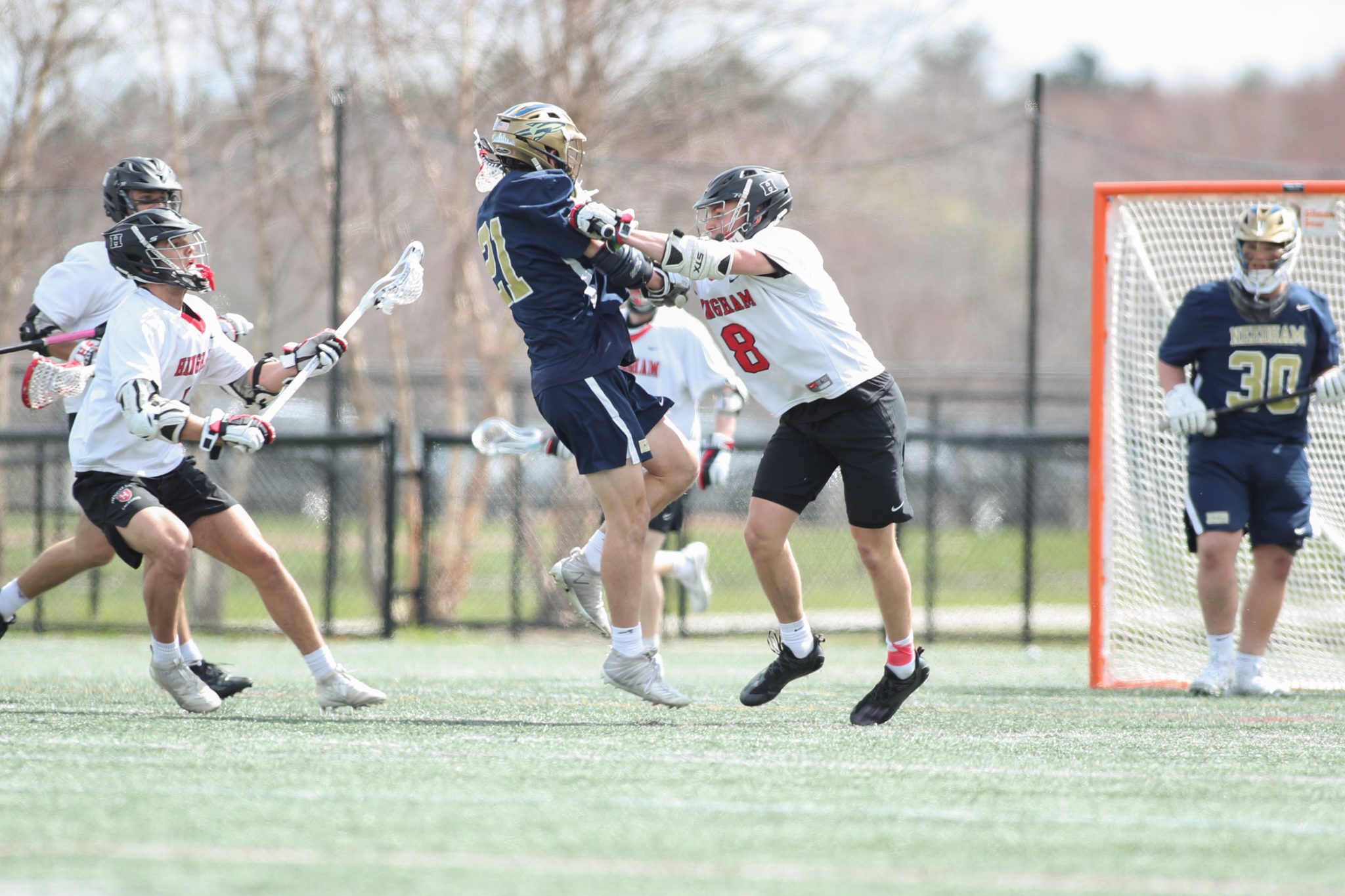 Senior captain Connor Hartman separates the ball from the Needham player late in Hingham's 10-4 win. 