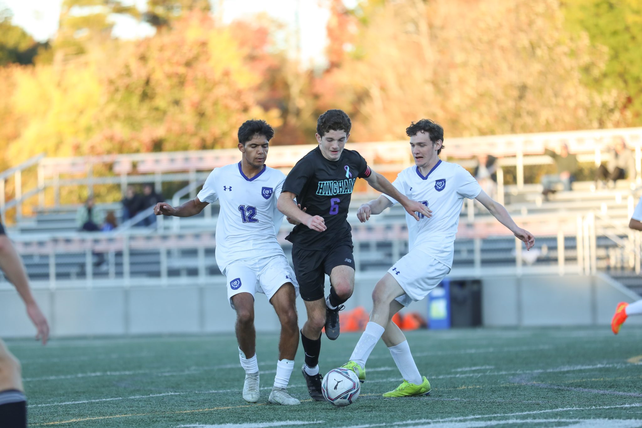 Senior captain Griffin Coppola splits two defenders in Saturday's 7-0 win over Quincy.