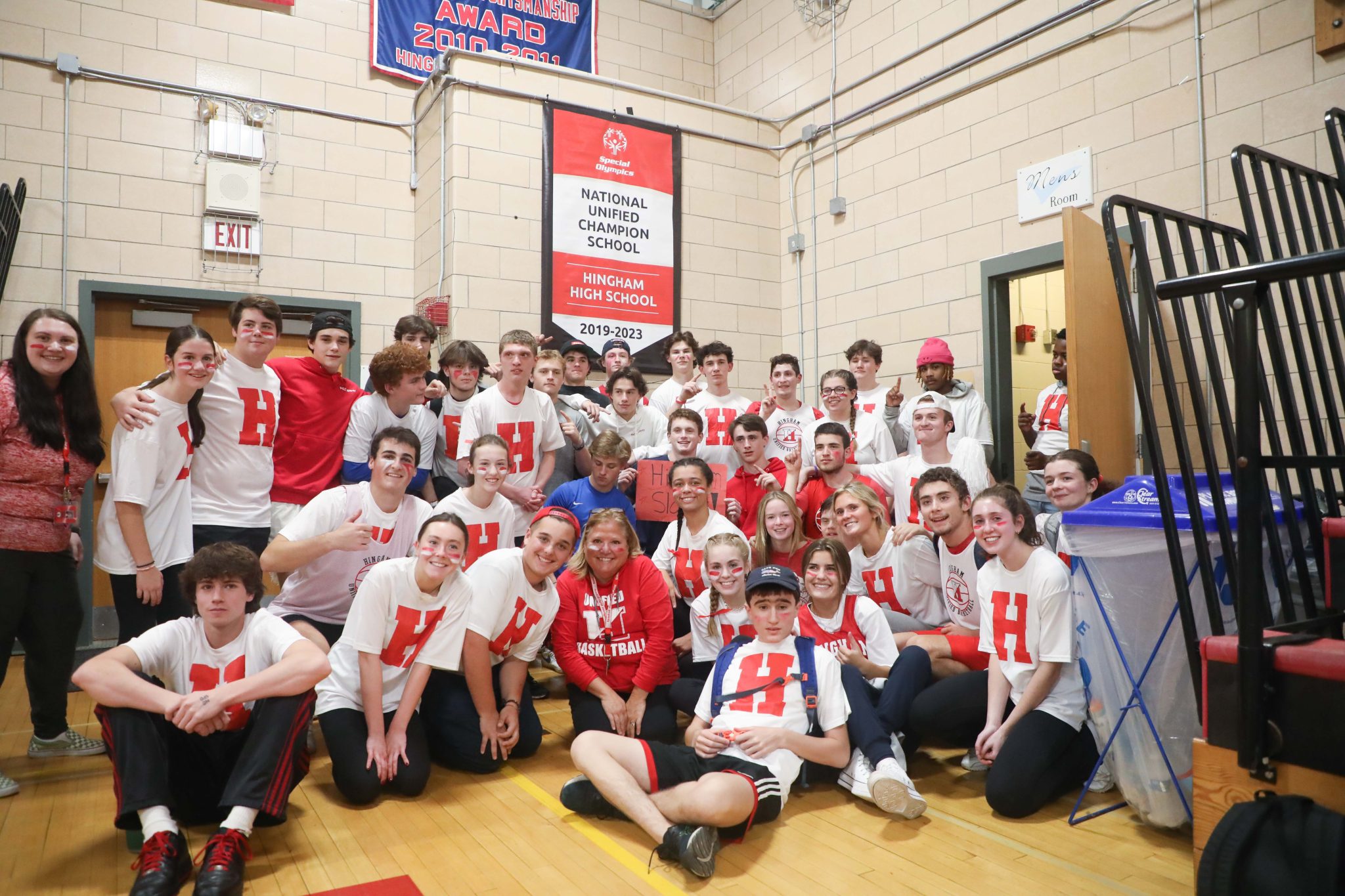 Members of Hingham's Unified basketball team unveiled the banner recognizing Hingham High as a Champion School by Special Olympics.