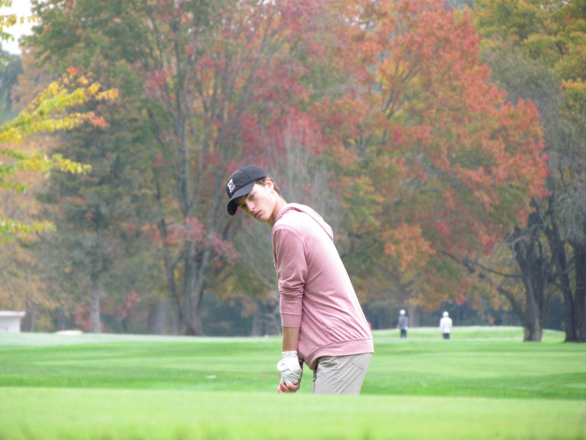 Junior Carson Erick chips onto the green during the D1 South Sectionals.