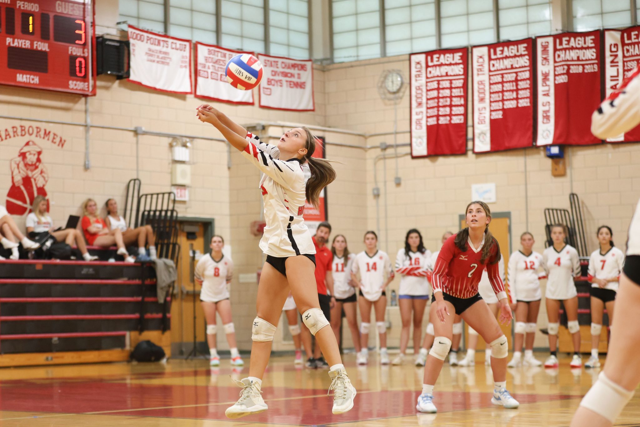 Senior Mia Sacco sets her teammate early in the third set of Hingham's 3-0 season opening match vs Cohasset. 